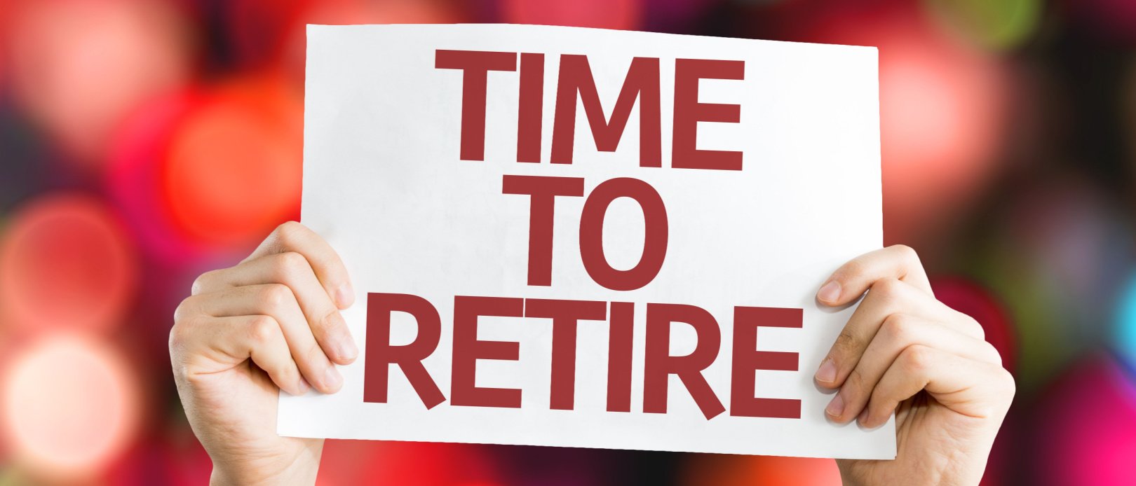 Holding sign saying Time to Retire